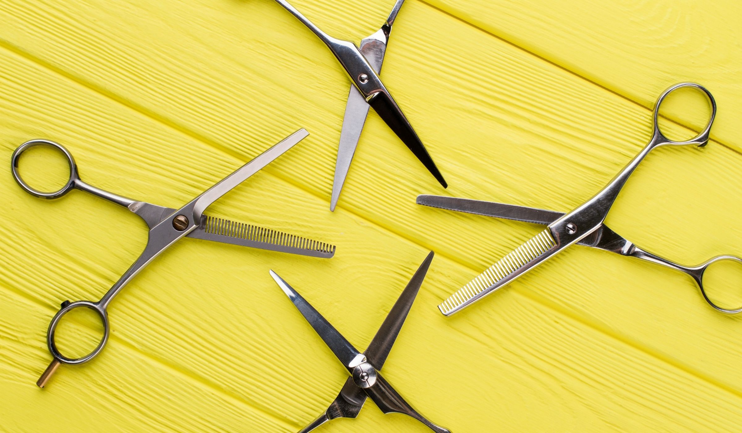 A collection of Mina Scissors on a yellow background