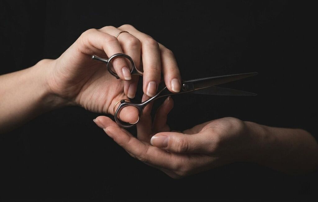 Professional hairdresser actively cutting hair with natural window light in a Japanese salon