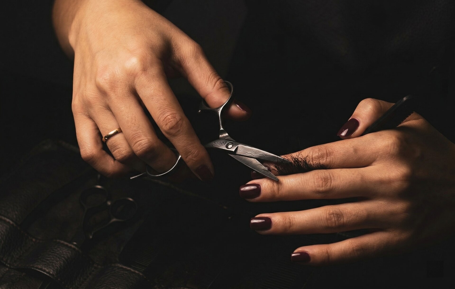 Professional Mina Black Diamond scissors held in hands showing ergonomic design and blade detail