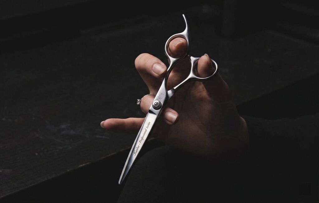 Mina Timeless professional scissor with brown handle on dark moody background